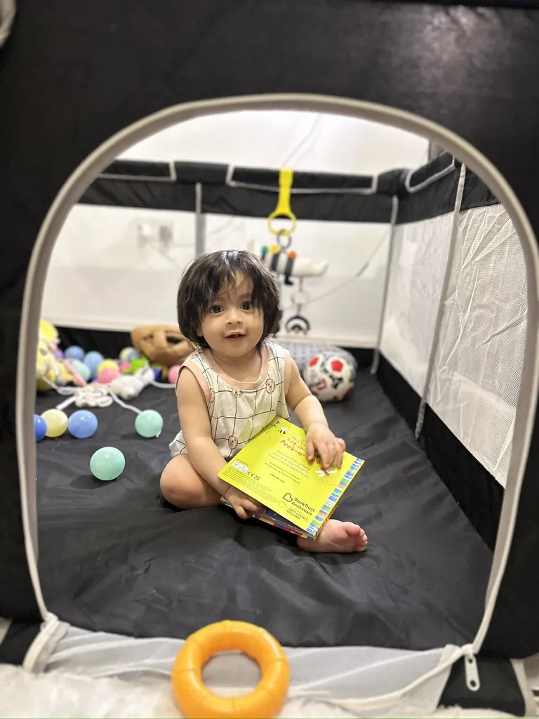Trayaksh playing peekaboo in a playpen during a candid content shoot